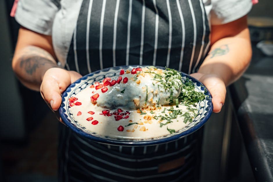 Explore the vibrant flavors of authentic chiles en nogada, a traditional Mexican dish served with creamy sauce.