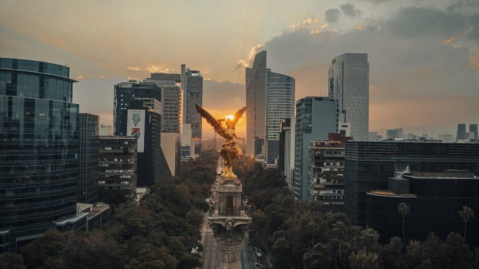 A stunning aerial view of the Angel of Independence monument at sunset in Mexico City.
