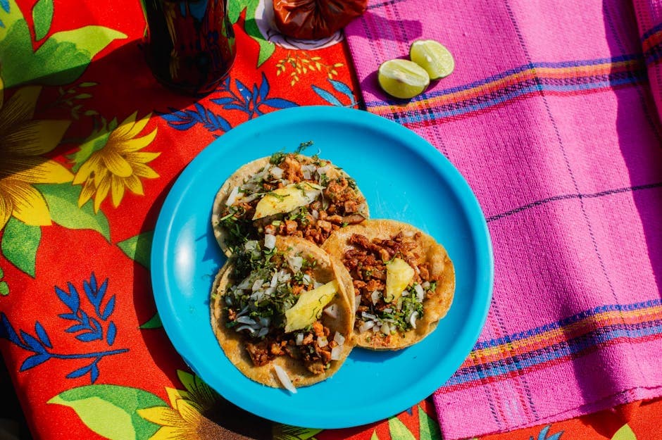 Delicious Mexican tacos with toppings on a colorful table setting in Mexico City.