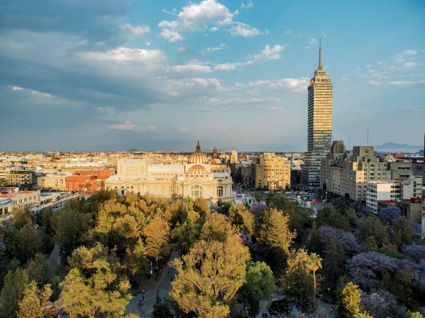 Stunning aerial view of Mexico City's skyline featuring Torre Latinoamericana and Palacio de Bellas Artes at sunset.