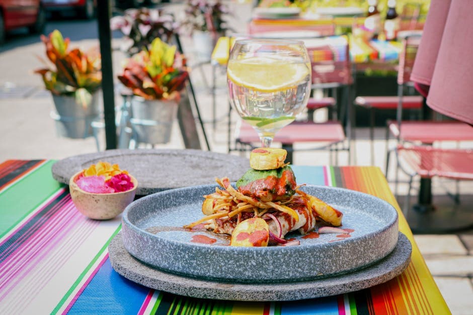 Colorful Mexican cuisine served on a vibrant table outdoors in Ciudad de México, showcasing culinary art.