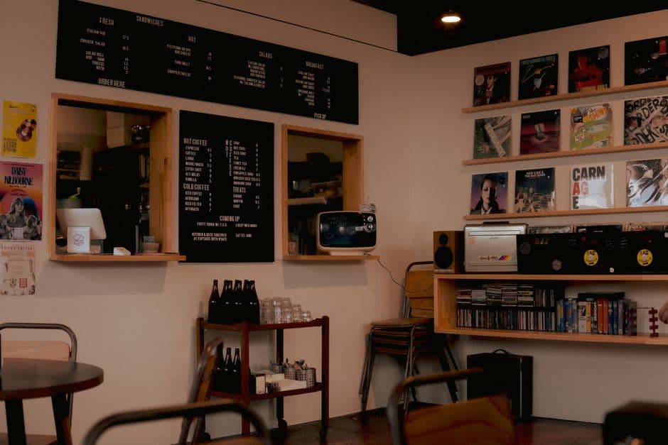 Charming café interior in Geelong featuring vinyl records, blackboard menu, and retro decor.