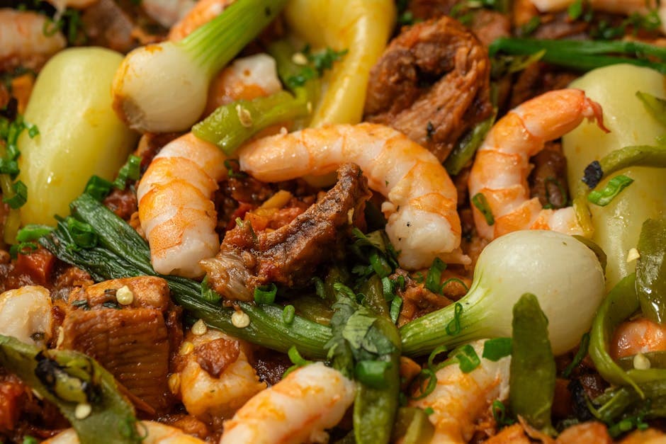A delicious dish featuring shrimp and beef with a vibrant assortment of vegetables, highlighting Mexican cuisine.