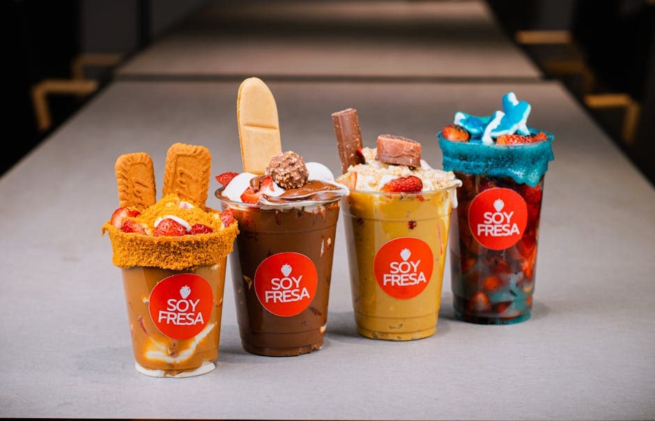 Colorful dessert cups from Soy Fresa featuring strawberries, cookies, chocolate, and more.