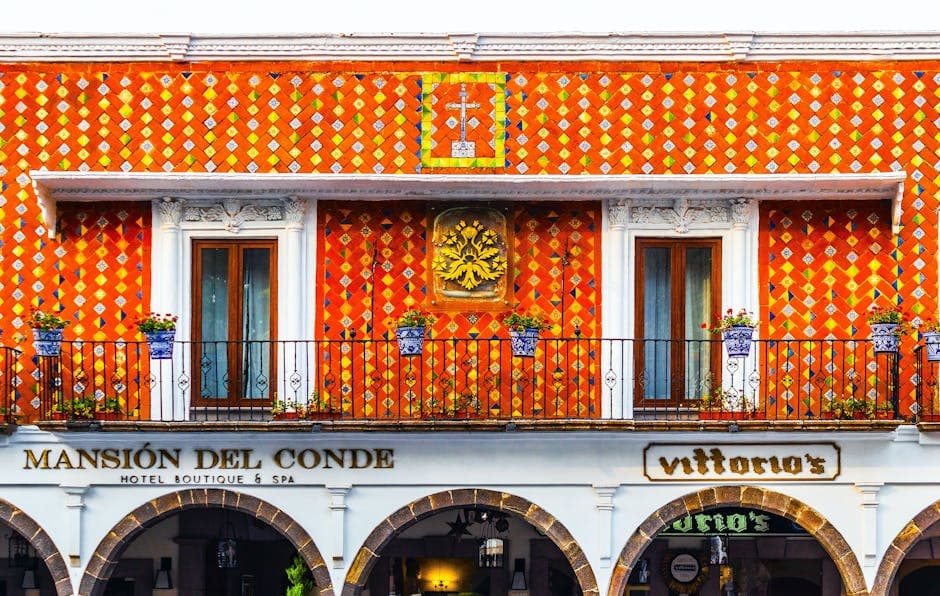 Exterior of aged building of hotel decorated with traditional colorful Talavera Mexican tiles located in Atlixco