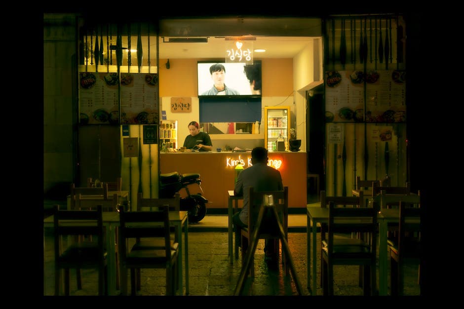 A man dines solo at an outdoor Korean restaurant at night in Santiago de Querétaro, Mexico.