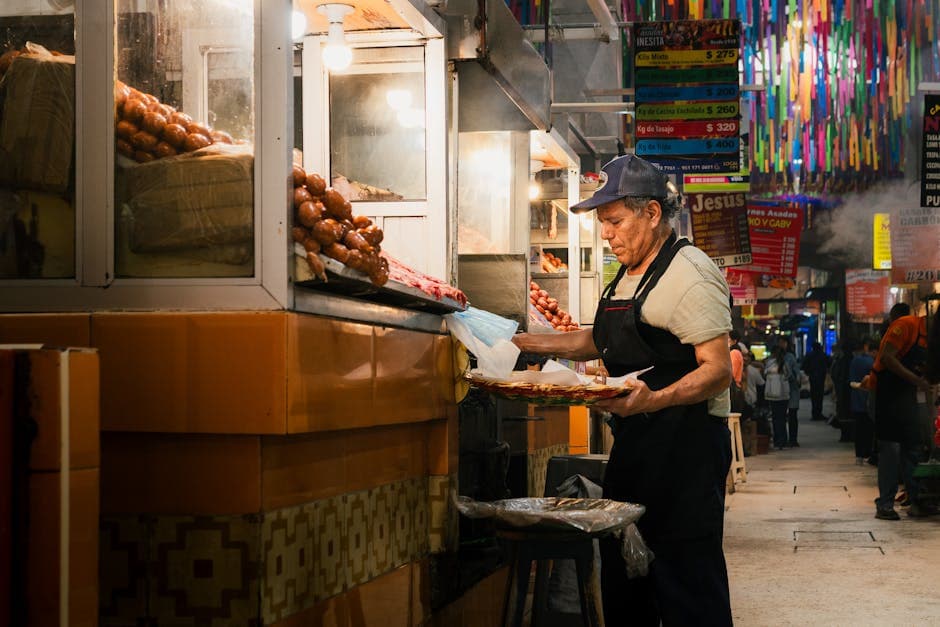A street vendor preparing and selling food at a vibrant market in Oaxaca de Juárez, Mexico.