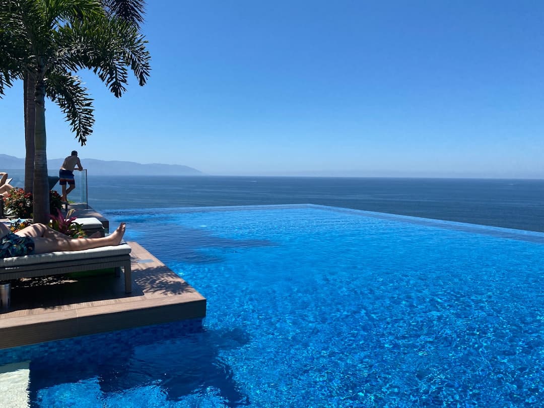 a large swimming pool next to the ocean