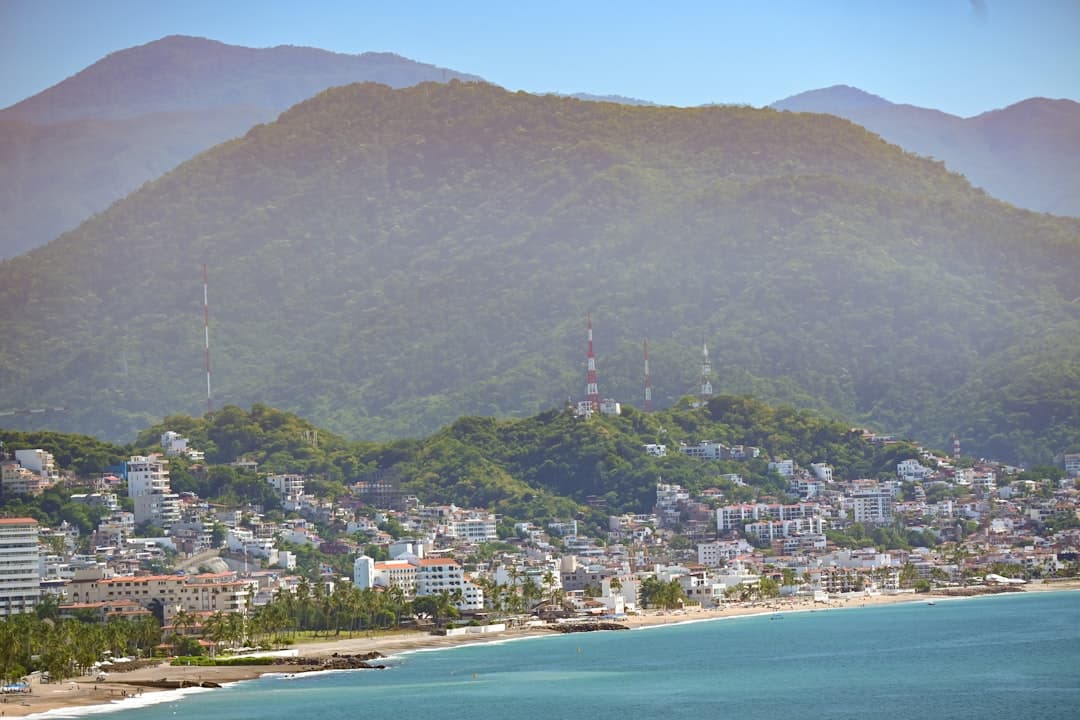 A view of a beach with mountains in the background