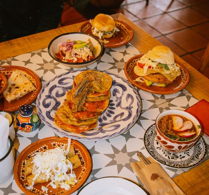 Delicious traditional Mexican cuisine displayed on a tiled table in San Pedro Cholula, Puebla.