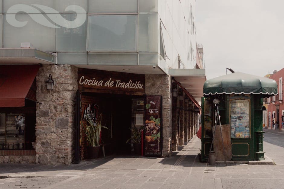 Street view in Puebla, Mexico featuring a traditional restaurant and urban architecture.