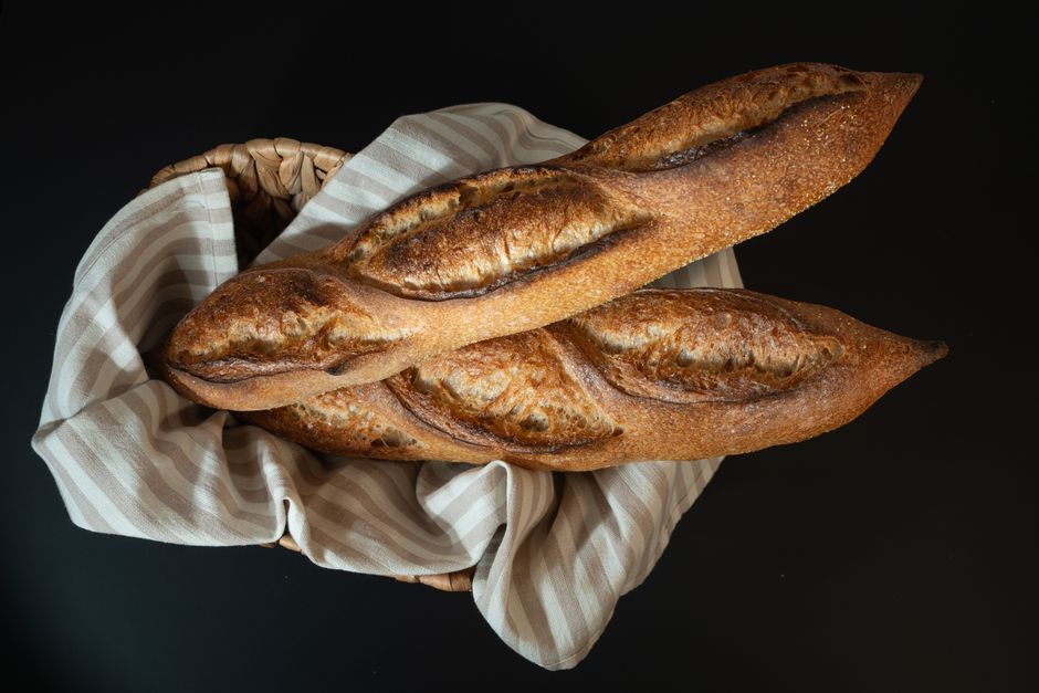Freshly baked artisan baguettes beautifully arranged in a basket.