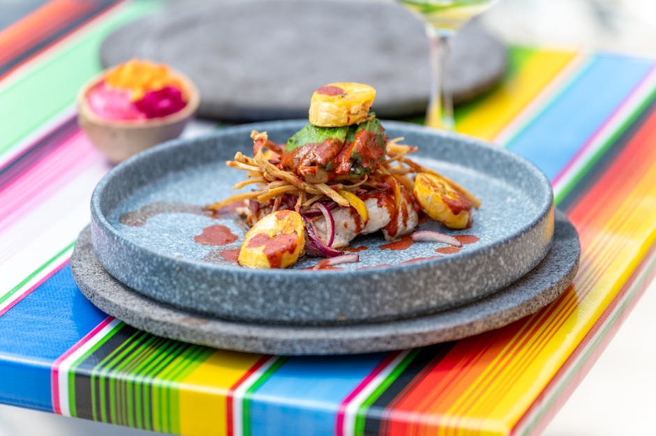 Vibrant Mexican cuisine with plantains and avocado served on a colorful table in CDMX.