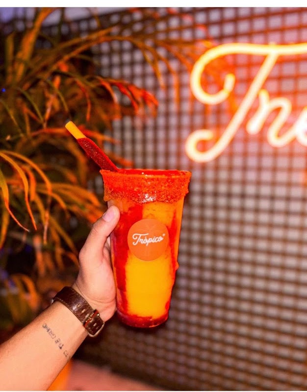 I BOBA YOU — close‑up of a mango‑passion fruit boba drink with tapioca pearls, bright signage on Magnolias 48