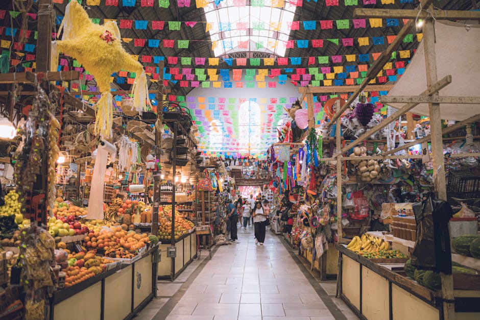 A colorful market in Guanajuato, Mexico bursting with fresh produce and traditional decorations.
