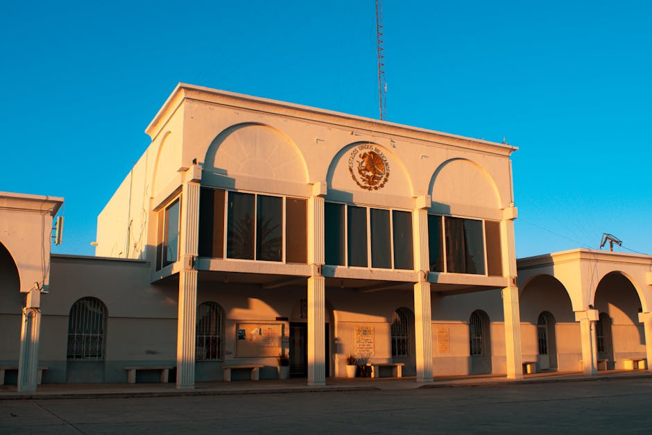 Colonial-style building in Pedro Meoqui, Mexico, featuring arches and a sunny facade.