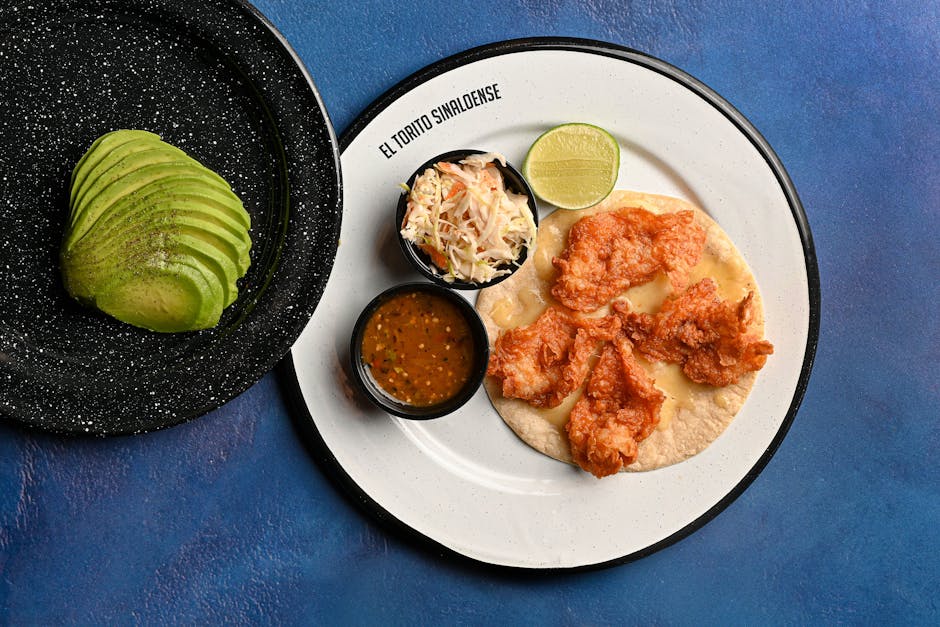 A vibrant seafood plate with avocado slices, served at El Torito Sinaloense, perfect for food photography.