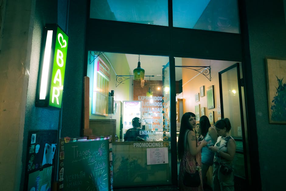 View of people outside a lively bar in Rosario, Argentina, at night.