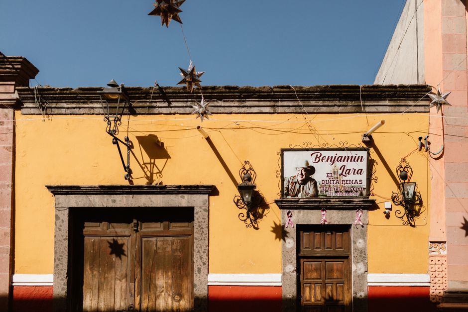 Vibrant yellow facade in San Miguel de Allende captures the essence of Mexican colonial architecture.