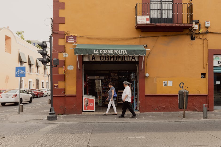 People walking past La Cosmopolita store in Puebla, Mexico, during the day.