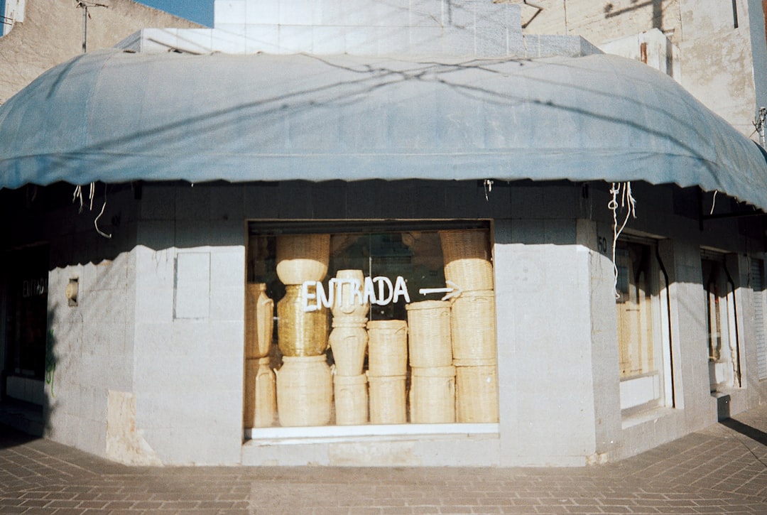 A building with a blue awning on the front of it