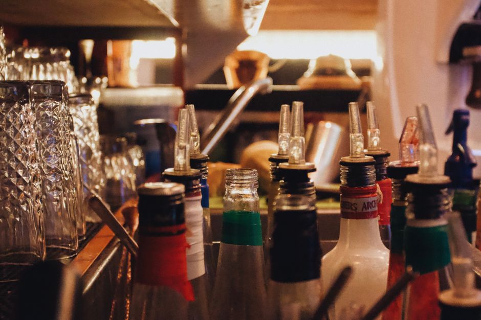Close-up of glass bottles with pourers at a bar in Szczecin, Poland. Perfect for mixology themes.