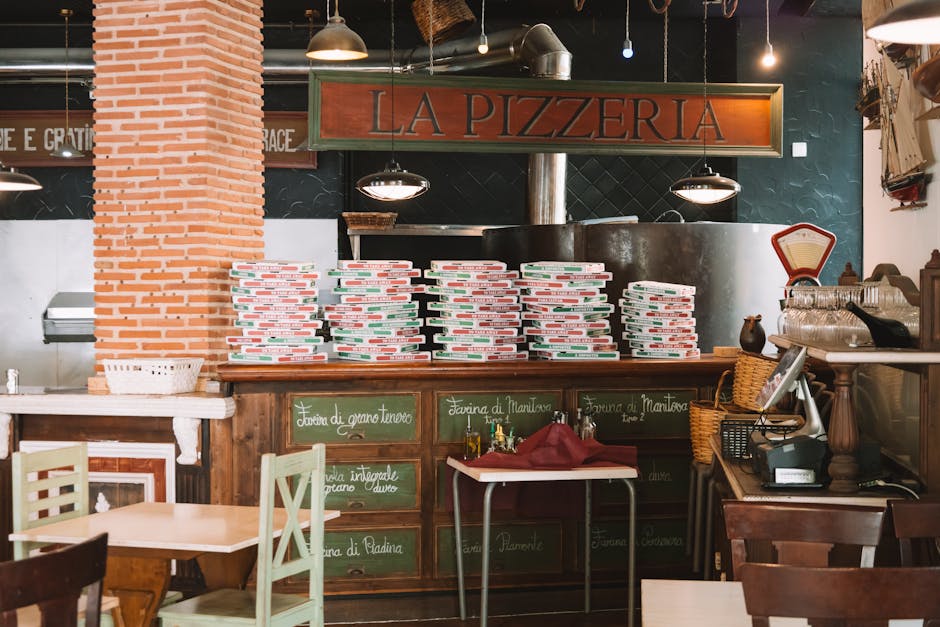 Cozy pizzeria interior with stacked pizza boxes and rustic decor in Valencia, Spain.