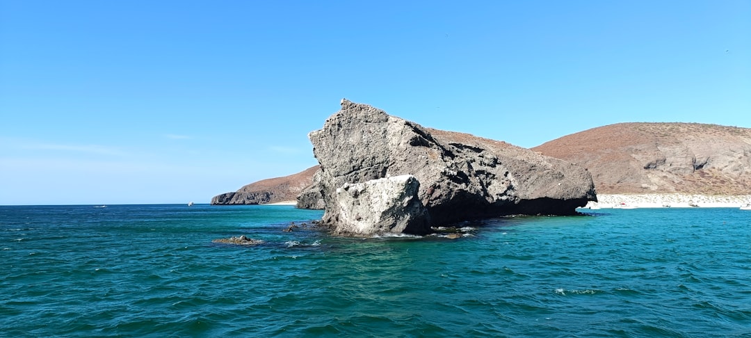 A large rock in the middle of the ocean