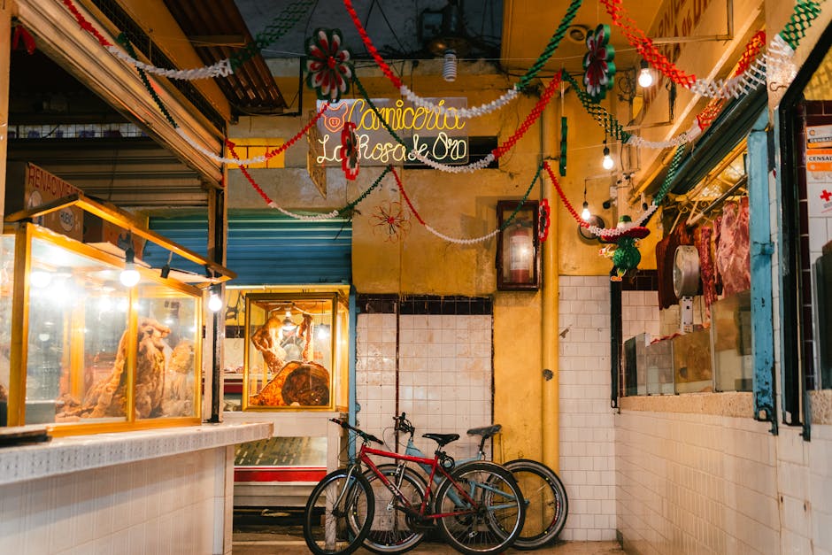 A colorful interior of a Mexican butcher shop decorated for celebration with bicycles.