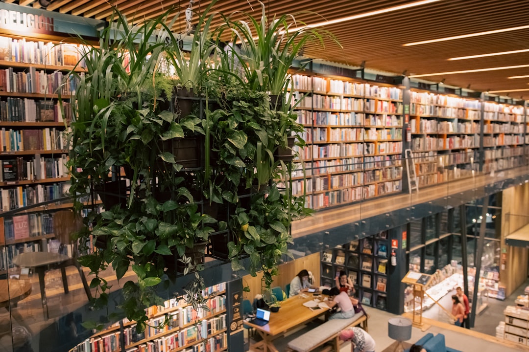 a library filled with lots of books and plants