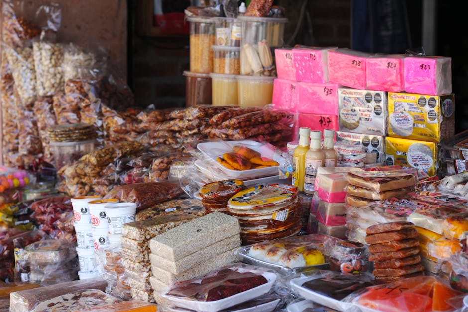 Vibrant display of traditional Mexican snacks at a bustling market stall.