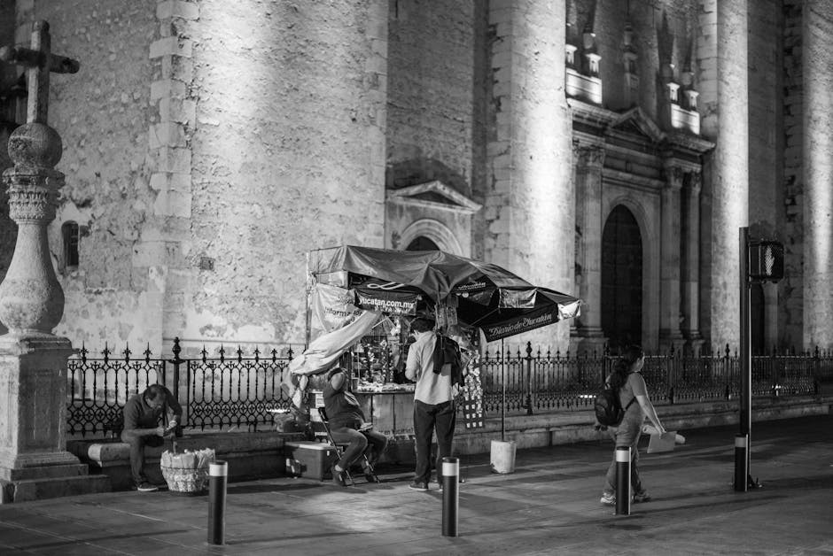 Black and white street photography of nighttime scene by Mérida Cathedral in Yucatán, Mexico.