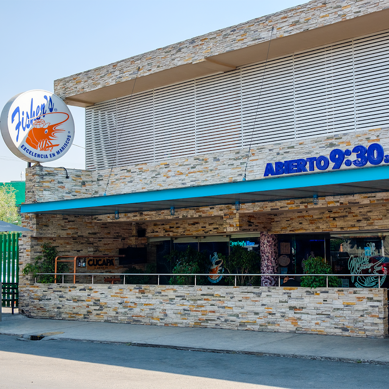 Fisher's storefront on P.º de los Mexicas 37, showing the sign and morning light