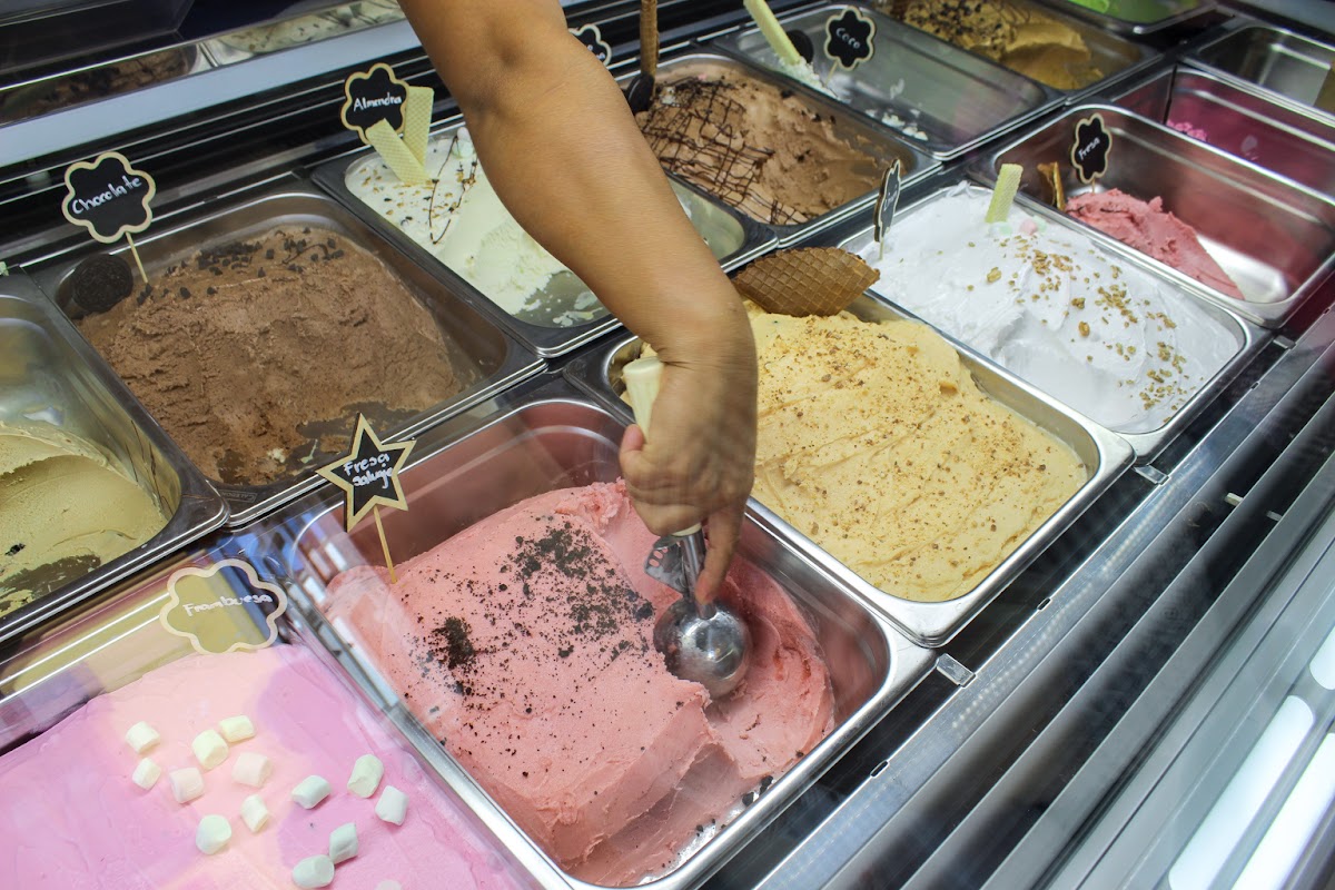 Copa de helado de cajeta y nuez con trozos de fruta en Alice in Gelatoland — primer plano del postre