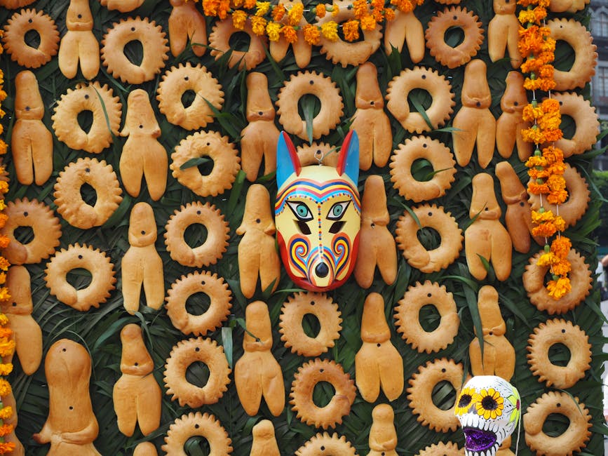 A vibrant display of traditional Mexican bread with a colorful Mexican mask.