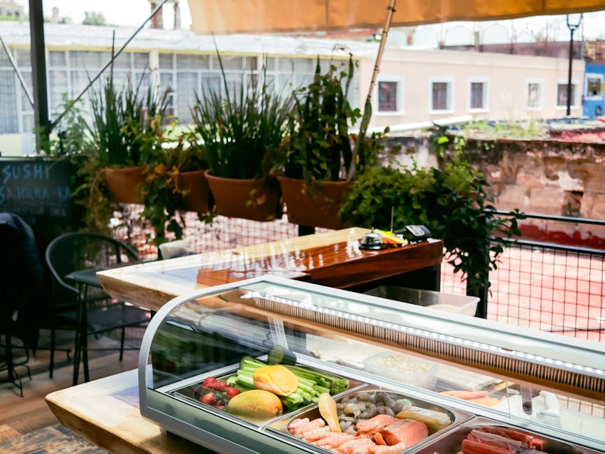 Capture of an outdoor sushi bar showcasing fresh seafood and vegetables in a vibrant setting.
