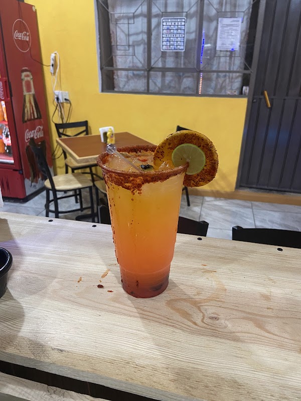 Puesto de antojitos en BUGUIS Zinacatepec mostrando una quesadilla de chicharrón y una bebida fresca — primer plano