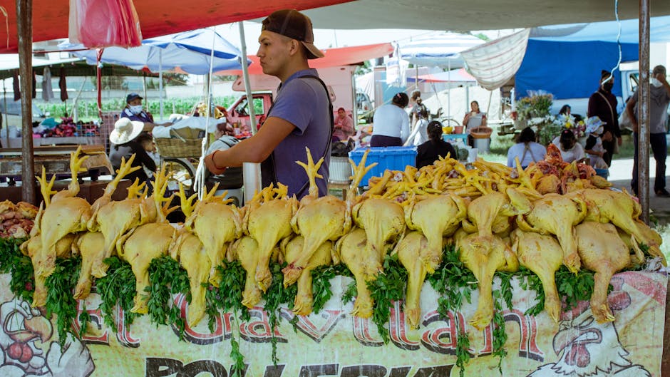 A vendor selling fresh chicken at an outdoor market in Cholula, Mexico.