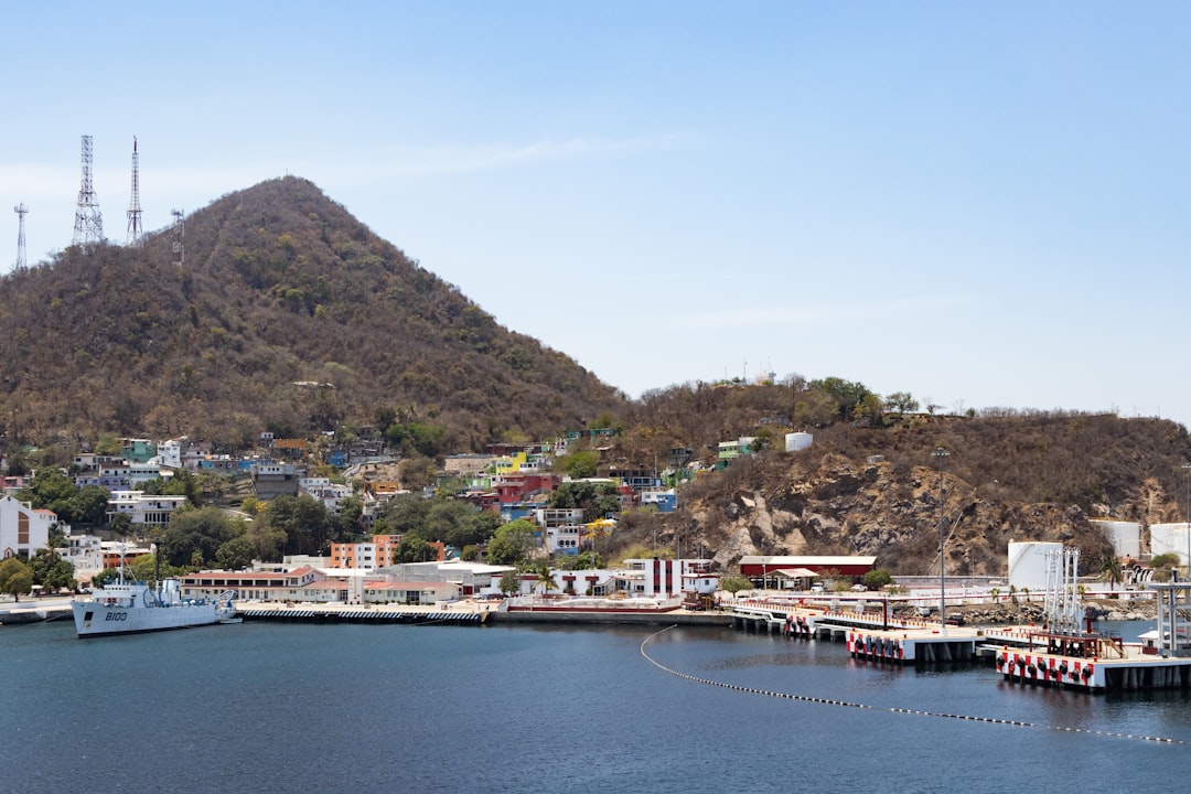 A body of water with a mountain in the background
