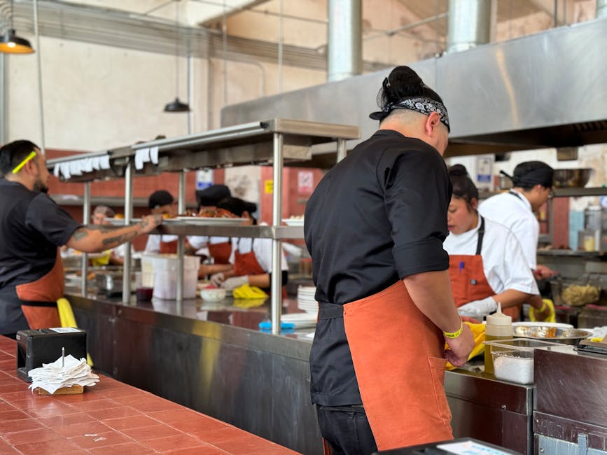 Chefs prepare dishes in a bustling kitchen in Santiago de Querétaro, Mexico.