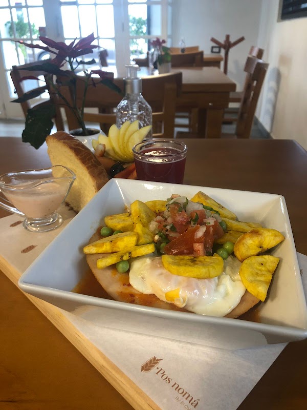 Pos nomás – table setting with chilaquiles and a cup of coffee, showing the generous portions