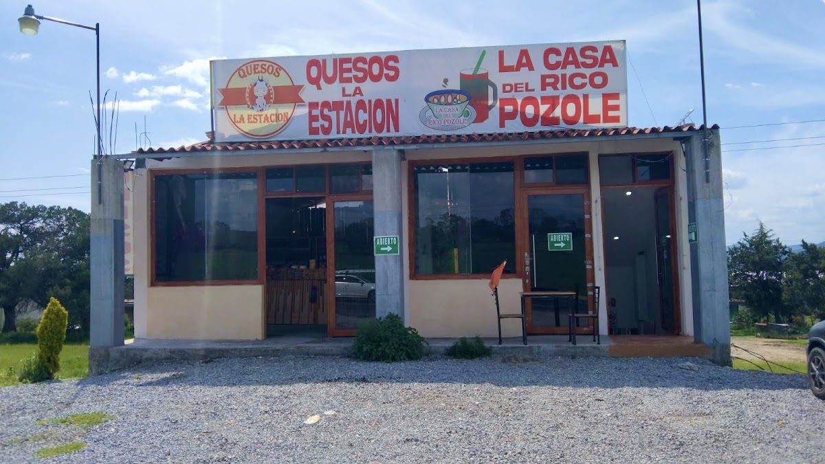 La Casa del Rico Pozole nueva sucursal serving a bowl of rojo pozole with lime and radish, interior at night