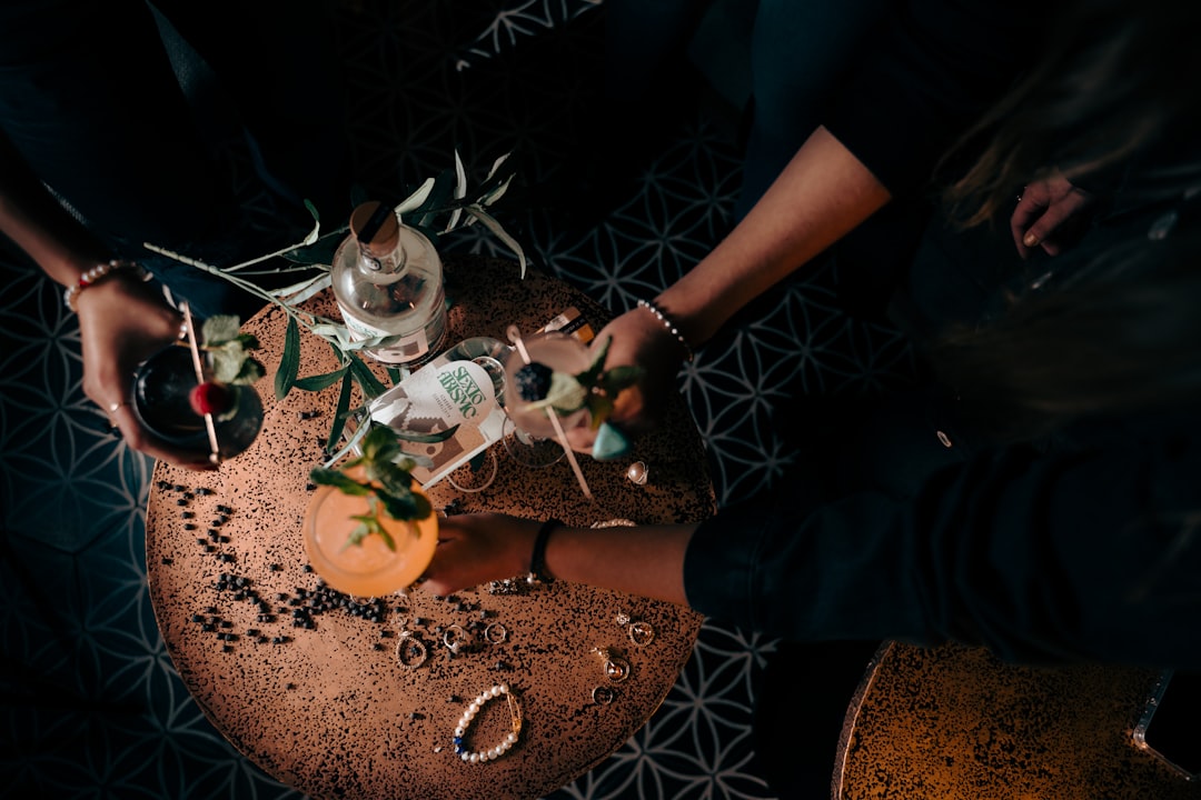 a group of people standing around a table with drinks