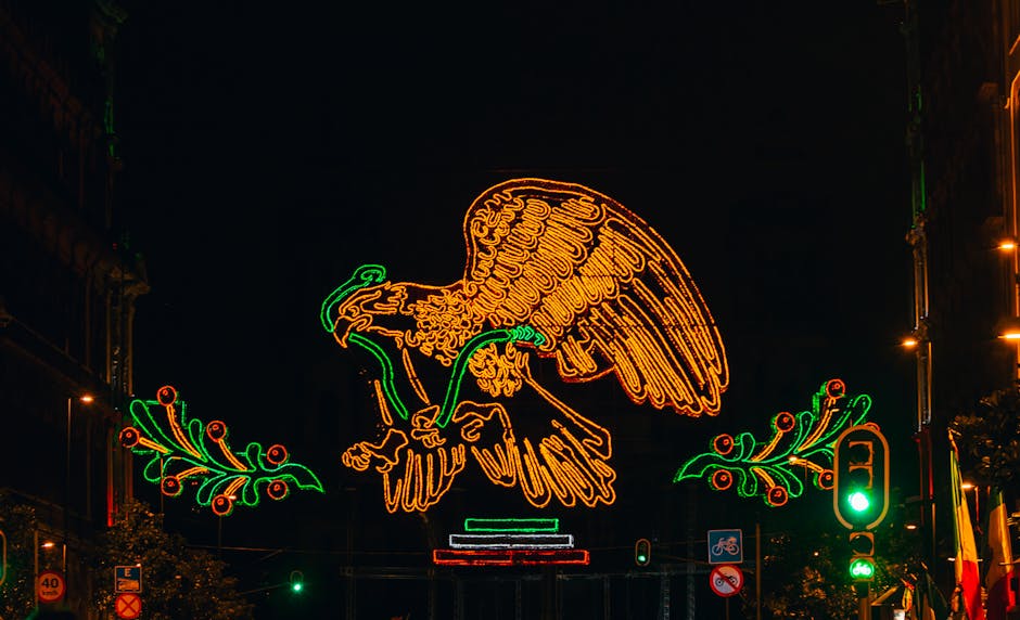 Vibrant neon lights of an eagle in downtown Mexico City at night.
