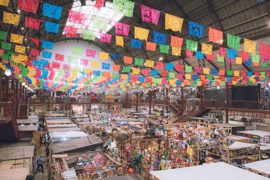 Vibrant interior of Mercado Hidalgo in Guanajuato with papel picado decorations.