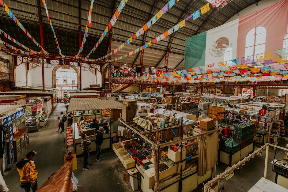 Colorful Mercado Hidalgo in Guanajuato, Mexico. High angle view showcasing vibrant market stalls and Mexican flags.