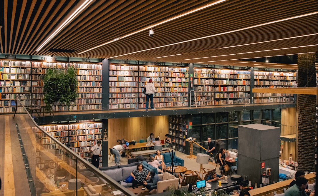 a library filled with lots of books and people