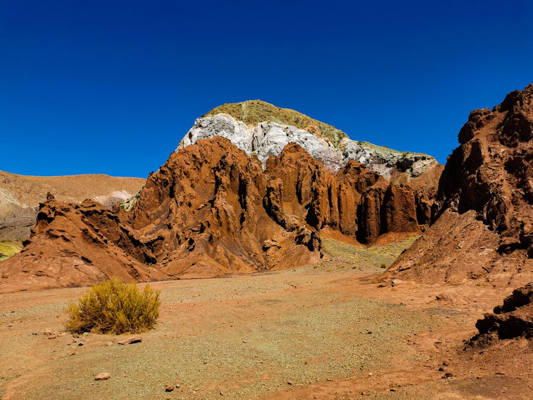 a rocky mountain with a snow covered peak
