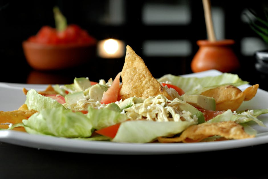 Vibrant Mexican salad featuring crisp lettuce, tortilla chips, avocado, and tomatoes.