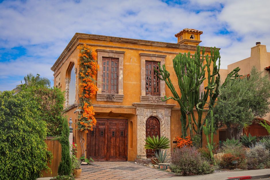 Elegant Mediterranean-style villa with vibrant flora in San Diego, CA.